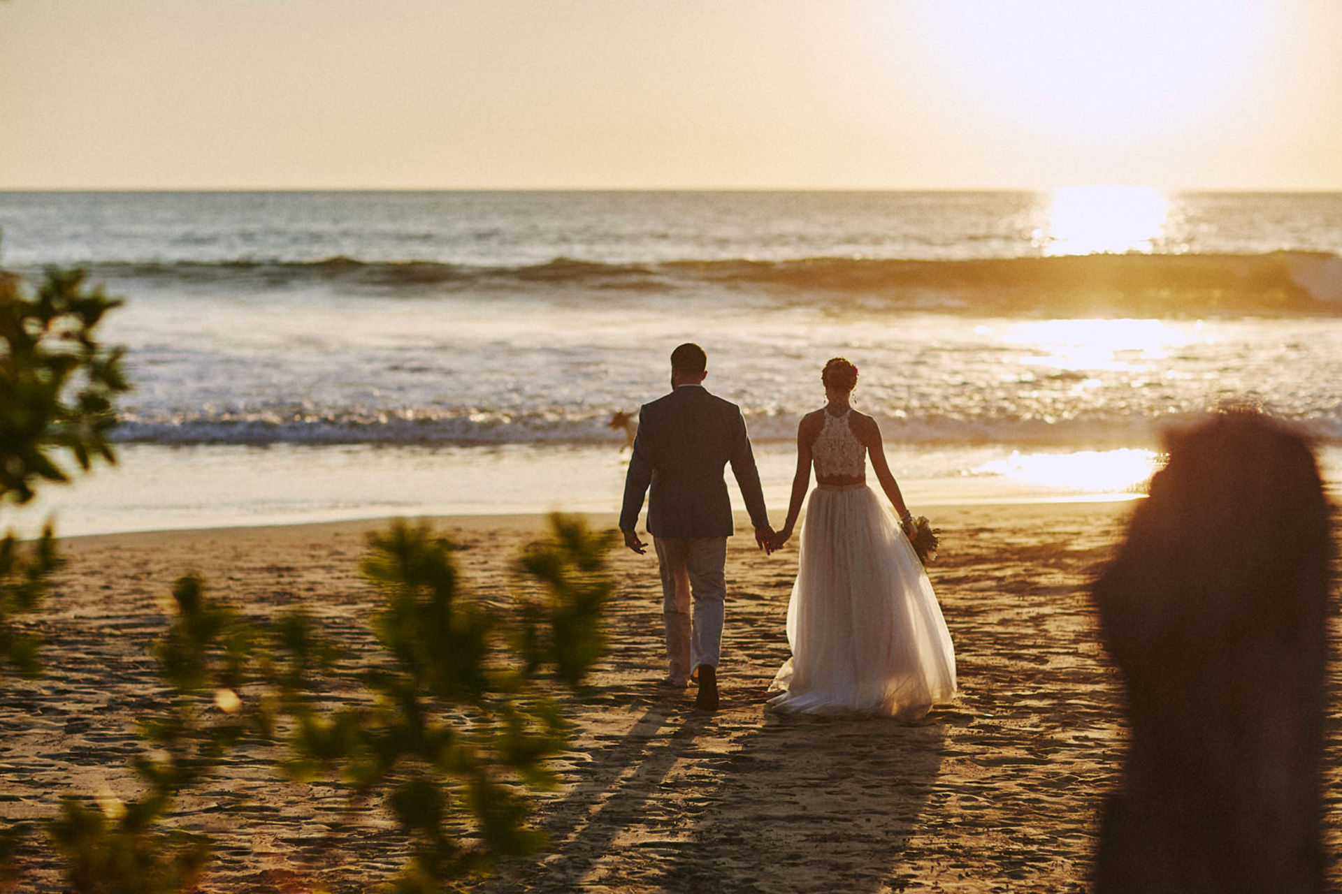 couple walking together beach sunset costa rica elopement